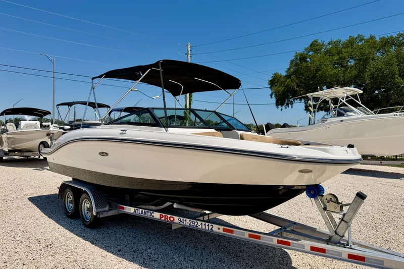 Slide: The Image of 2022 Sea Ray SPX 210 Outboard boat on trailer, displayed outdoors. - 3