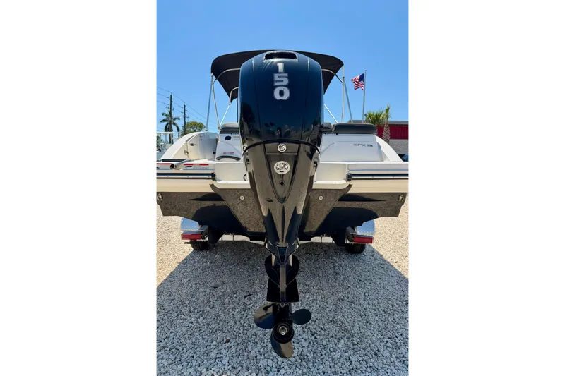 Slide: The Image of 2022 Sea Ray SPX 210 Outboard boat with 150 HP engine, parked on gravel. - 31