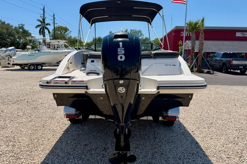 Slide: The Image of 2022 Sea Ray SPX 210 Outboard boat with 150 horsepower engine, parked on gravel. - 6