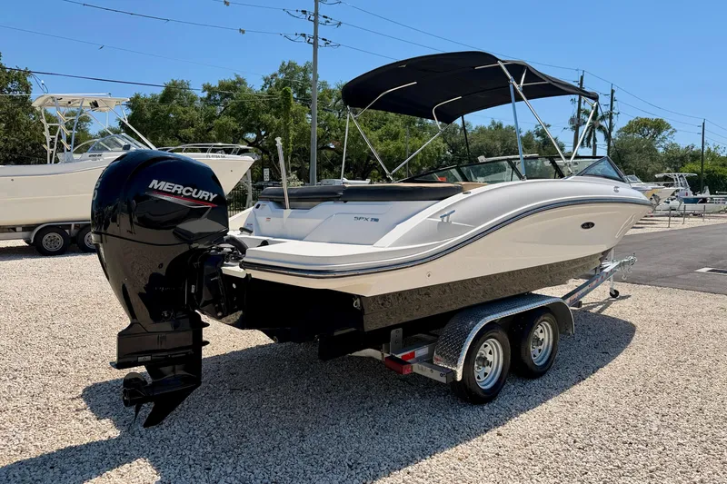 Slide: The Image of 2022 Sea Ray SPX 210 Outboard boat on trailer with Mercury engine, parked outdoors. - 7