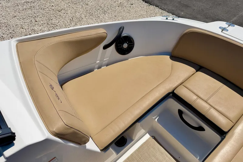 Slide: The Image of 2022 Sea Ray SPX 210 Outboard boat interior with tan seating and speaker. - 9