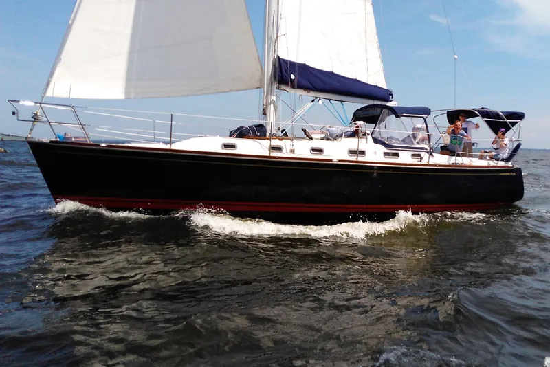 The Image of Sailing yacht Tartan 3700, 2001 model, cruising on open water with passengers. - 0