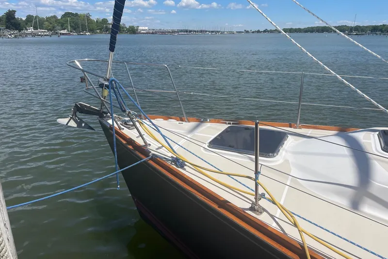 Slide: The Image of Sailboat Tartan 3700 (2001) docked on calm water under a clear sky. - 1