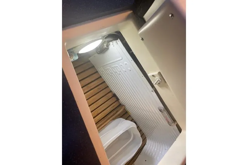 Slide: The Image of Interior view of a 2001 Tartan 3700 sailboat, featuring a compact storage area. - 11
