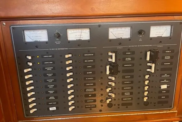Slide: The Image of Electrical control panel on a 2001 Tartan 3700 yacht, featuring switches and gauges. - 15