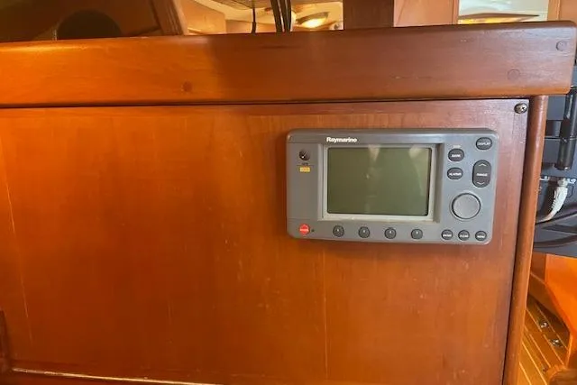 Slide: The Image of Raymarine navigation system on 2001 Tartan 3700 yacht's wooden interior panel. - 16