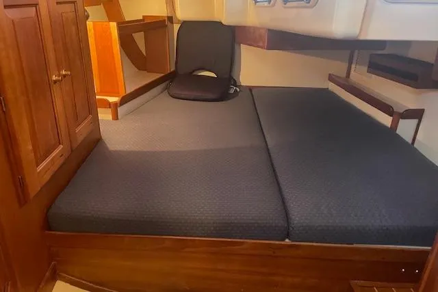 Slide: The Image of Interior cabin of 2001 Tartan 3700 sailboat with cushioned seating and wooden cabinetry. - 17