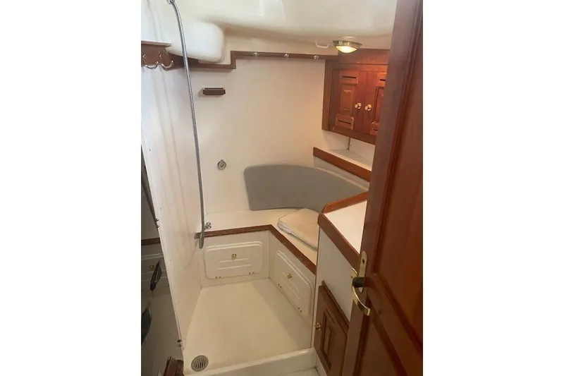 Slide: The Image of Interior of 2001 Tartan 3700 sailboat with wooden cabinetry and seating area. - 18