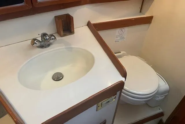 Slide: The Image of Bathroom interior of a 2001 Tartan 3700 yacht, featuring a sink and toilet. - 19