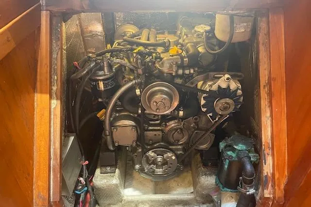 Slide: The Image of Engine compartment of a 2001 Tartan 3700 sailboat, showcasing mechanical components. - 20
