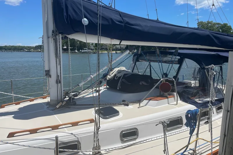 Slide: The Image of Sailboat Tartan 3700, 2001 model, docked by a serene waterfront. - 3