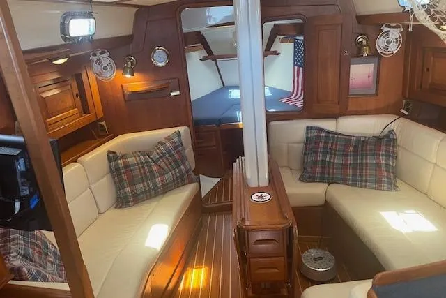 Slide: The Image of Luxurious 2001 Tartan 3700 yacht interior with plush seating and elegant wood finishes. - 5