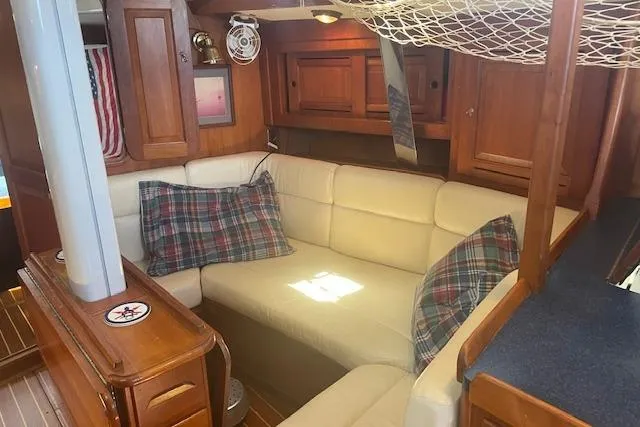Slide: The Image of Cozy interior of 2001 Tartan 3700 sailboat with plaid pillows and wooden cabinetry. - 6