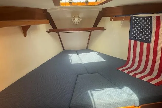 Slide: The Image of Cozy cabin interior of 2001 Tartan 3700 sailboat with American flag decor. - 9