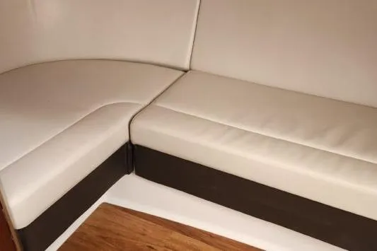 Slide: The Image of 2023 Chaparral 347 SSX interior seating with white and brown upholstery. - 12