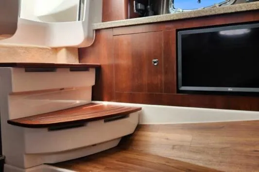 Slide: The Image of Interior of 2023 Chaparral 347 SSX boat with wooden steps and cabinetry. - 13