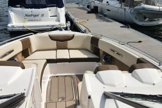 Slide: The Image of 2023 Chaparral 347 SSX boat interior with beige seating at dock. - 3
