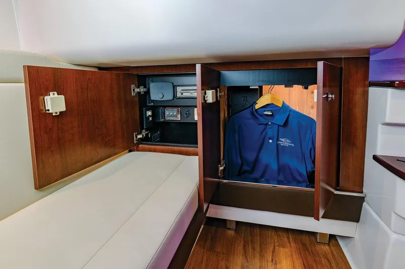Slide: The Image of Manufacturer Provided Image: 2023 Chaparral 347 SSX cabin storage with wooden cabinets and hanging space. - 36