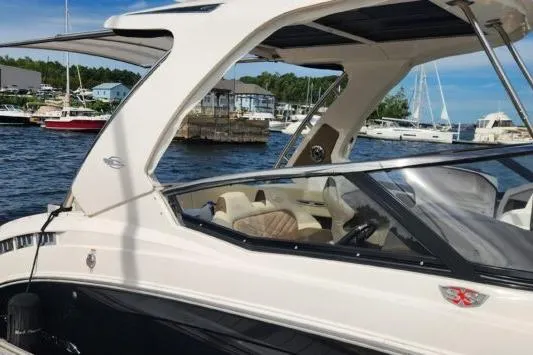 Slide: The Image of 2023 Chaparral 347 SSX boat docked at marina, showcasing sleek design and luxury features. - 5