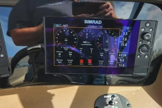 Slide: The Image of Simrad display on 2023 Chaparral 347 SSX boat dashboard showing navigation and performance data. - 6