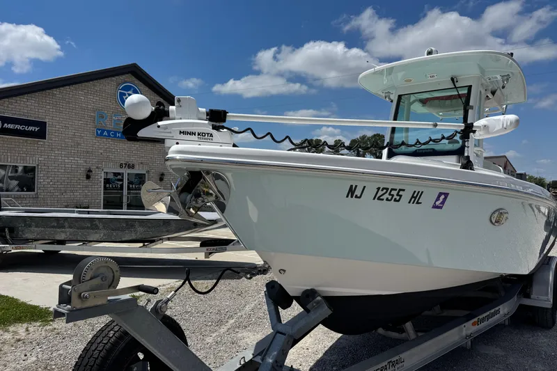 Slide: The Image of 2020 Everglades 253 Center Console boat on trailer at dealership, featuring Minn Kota Terrova motor. - 8
