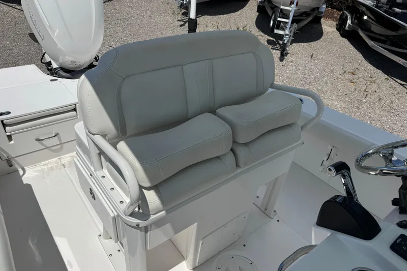 Slide: The Image of 2020 Everglades 253 Center Console boat interior with cushioned seating and steering console. - 9