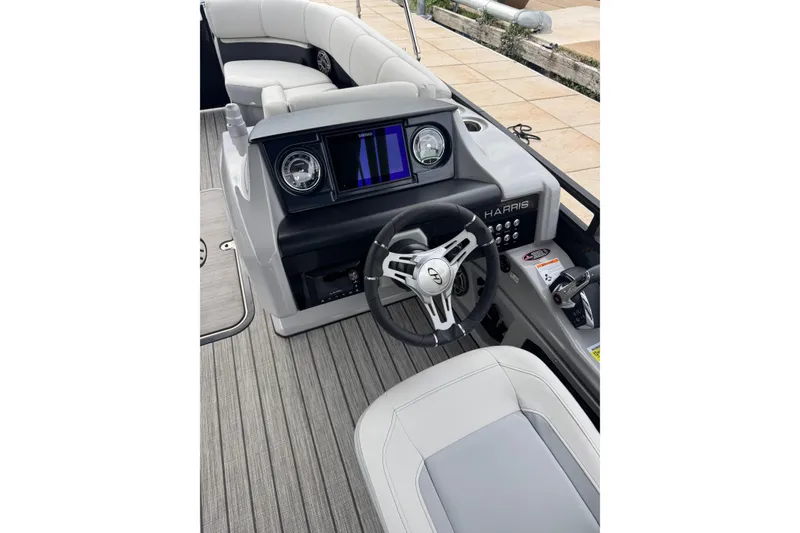 Slide: The Image of 2023 Harris Solstice 230 boat interior with modern dashboard and steering wheel. - 10