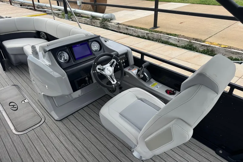 Slide: The Image of 2023 Harris Solstice 230 boat interior with modern helm, plush seating, and sleek design. - 12