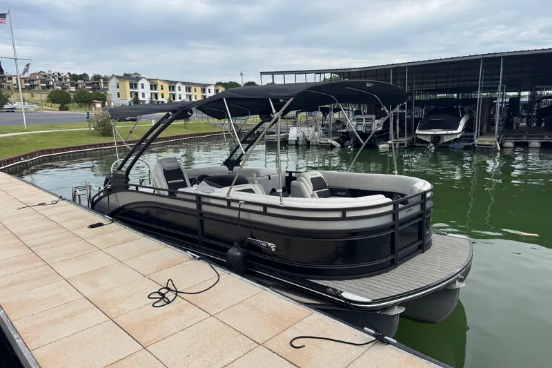 Slide: The Image of 2023 Harris Solstice 230 pontoon boat docked at a marina. - 4