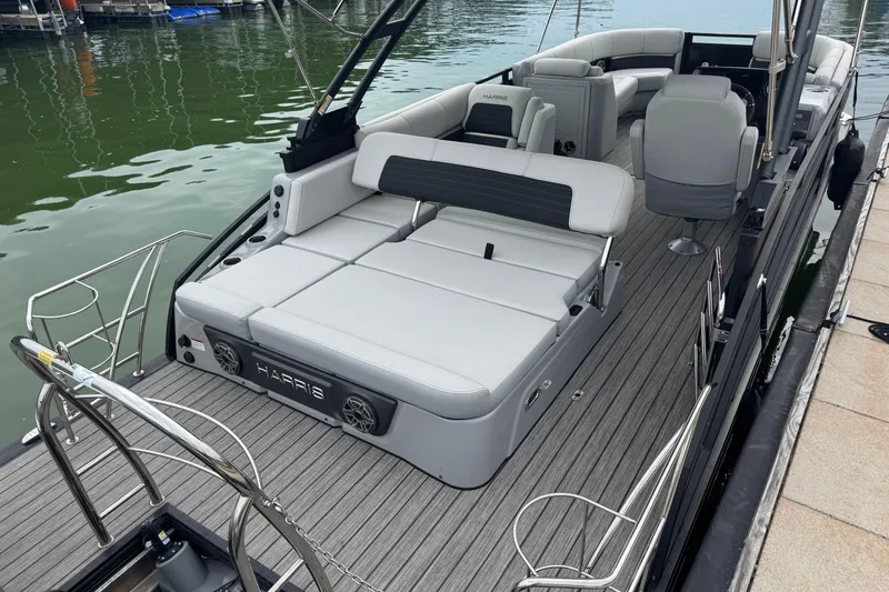 Slide: The Image of 2023 Harris Solstice 230 pontoon boat with luxurious seating and sleek design at the dock. - 7
