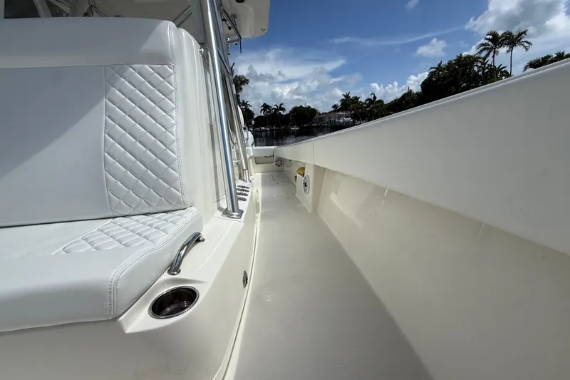 Slide: The Image of 2018 SeaVee 340Z boat interior with white seating and clear skies. - 10