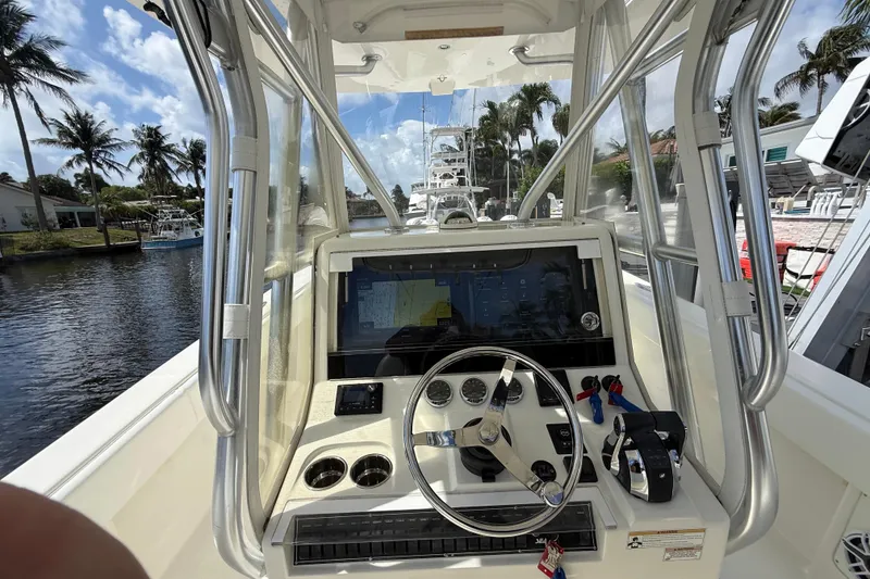 Slide: The Image of 2018 SeaVee 340Z boat cockpit with steering wheel, controls, and navigation screen. - 12