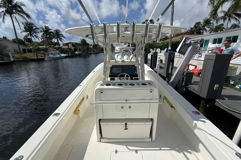 Slide: The Image of 2018 SeaVee 340Z boat docked in a scenic canal with palm trees. - 15