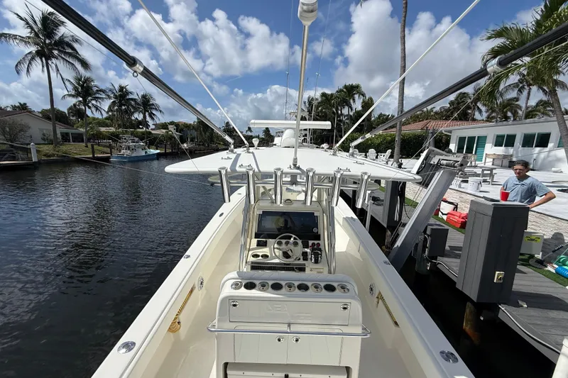 Slide: The Image of 2018 SeaVee 340Z boat docked by a canal with palm trees and blue sky. - 18