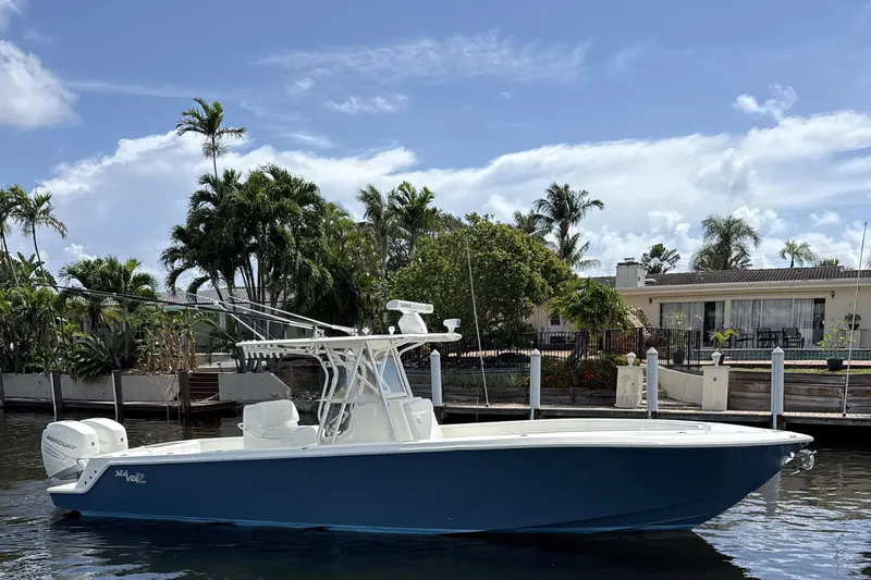Slide: The Image of 2018 SeaVee 340Z boat docked by a waterfront home with palm trees. - 3