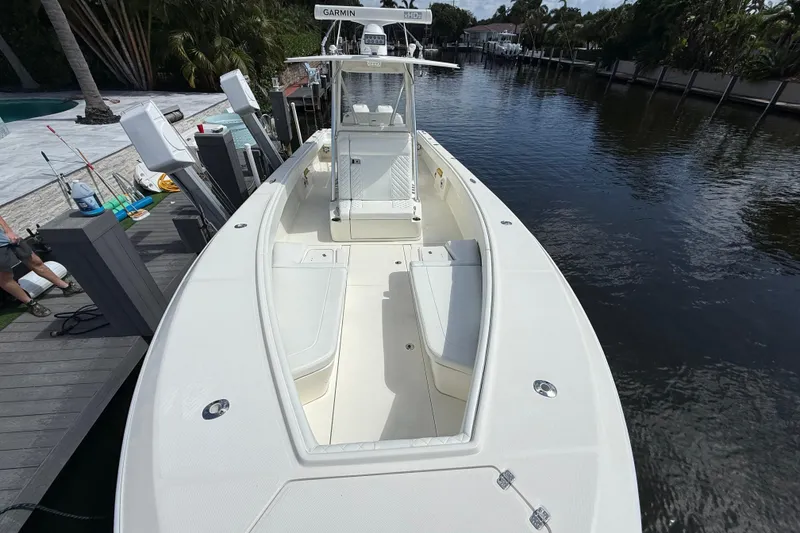 Slide: The Image of 2018 SeaVee 340Z boat docked, featuring spacious deck and modern navigation equipment. - 4