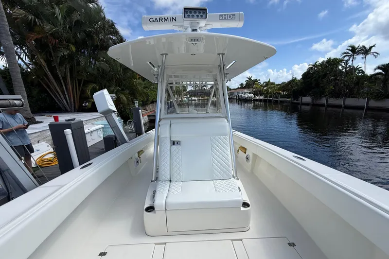 Slide: The Image of 2018 SeaVee 340Z boat with Garmin equipment, docked by a scenic waterway. - 6