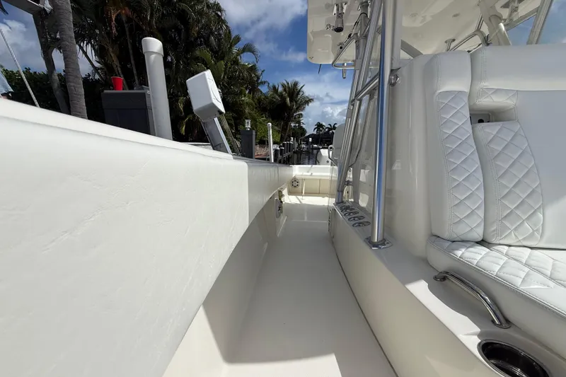 Slide: The Image of 2018 SeaVee 340Z boat interior with white seating and stainless steel accents. - 9