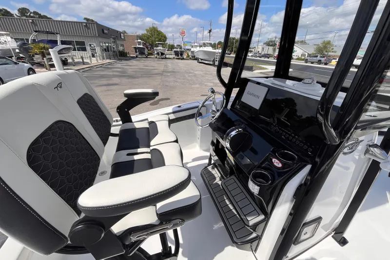 Slide: The Image of 2026 Tidewater 210 LXF boat interior with modern helm and seating, featuring Garmin navigation. - 14