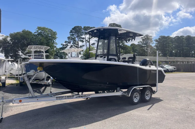 Slide: The Image of 2026 Tidewater 210 LXF boat on trailer under blue sky. - 2