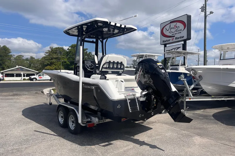Slide: The Image of 2026 Tidewater 210 LXF boat on trailer at Marker 17 Marine dealership. - 3