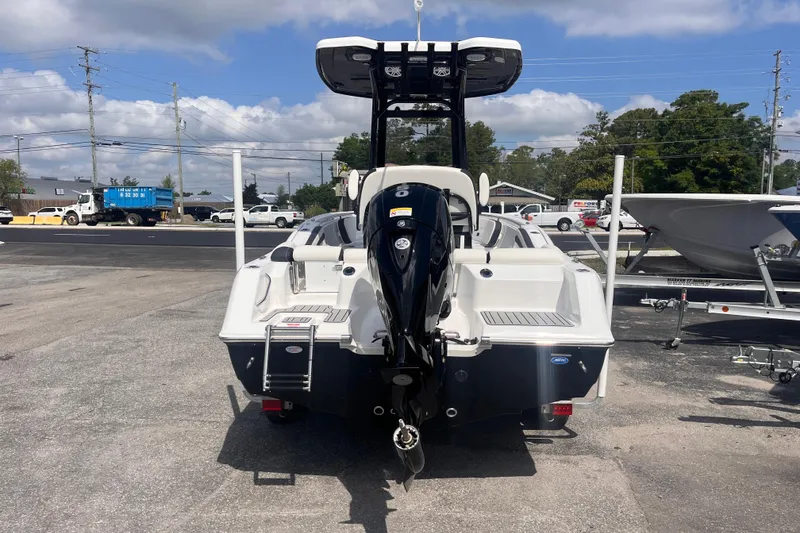 Slide: The Image of 2026 Tidewater 210 LXF boat with outboard motor, parked outdoors under a cloudy sky. - 4