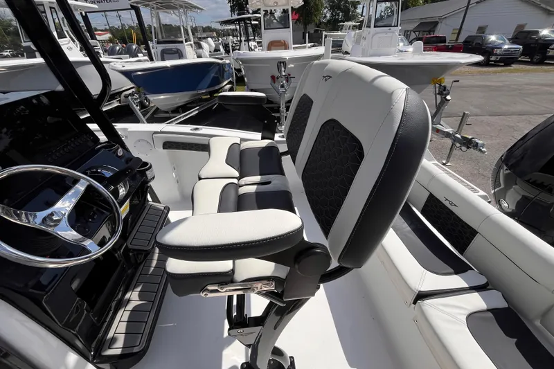 Slide: The Image of 2026 Tidewater 210 LXF boat interior with modern seating and steering wheel. - 6