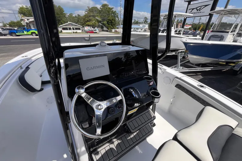 Slide: The Image of 2026 Tidewater 210 LXF boat interior with Garmin navigation system and sleek steering console. - 7