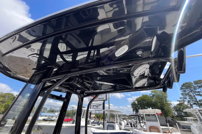 Slide: The Image of Tidewater 210 LXF 2026 boat with sleek black T-top and integrated speakers. - 8