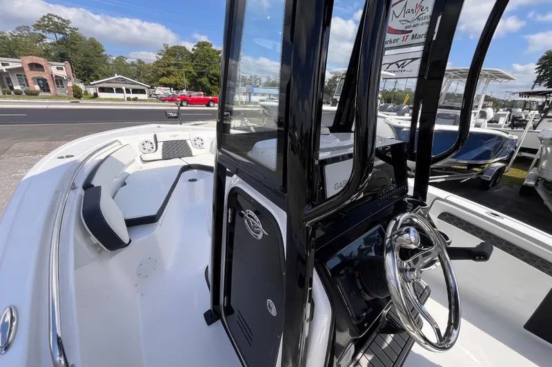 Slide: The Image of 2026 Tidewater 210 LXF boat interior with steering wheel and seating area. - 9