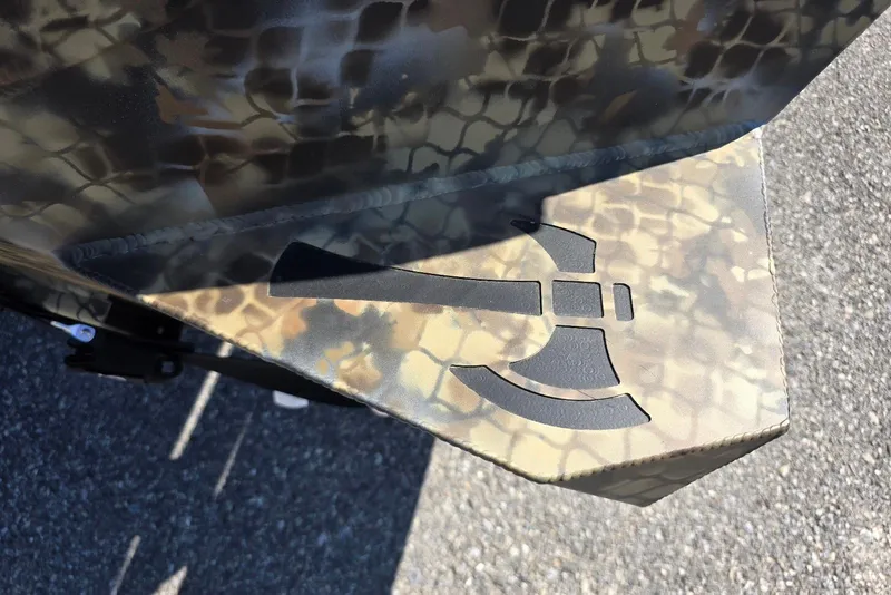 Slide: The Image of Camouflage-patterned Excel 183 Tomahawk boat detail with tomahawk logo, 2026 model. - 10