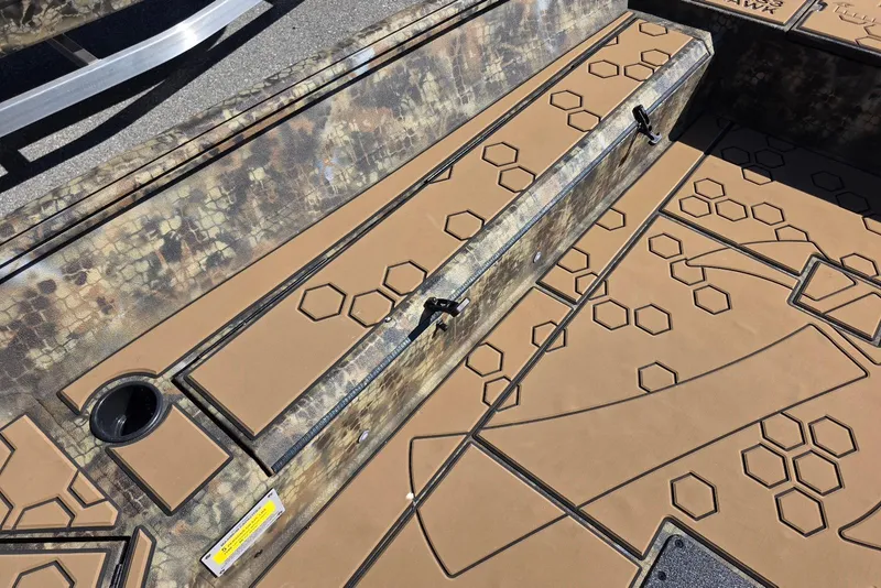 Slide: The Image of 2026 Excel 183 Tomahawk boat interior with hexagonal pattern design and storage compartments. - 12