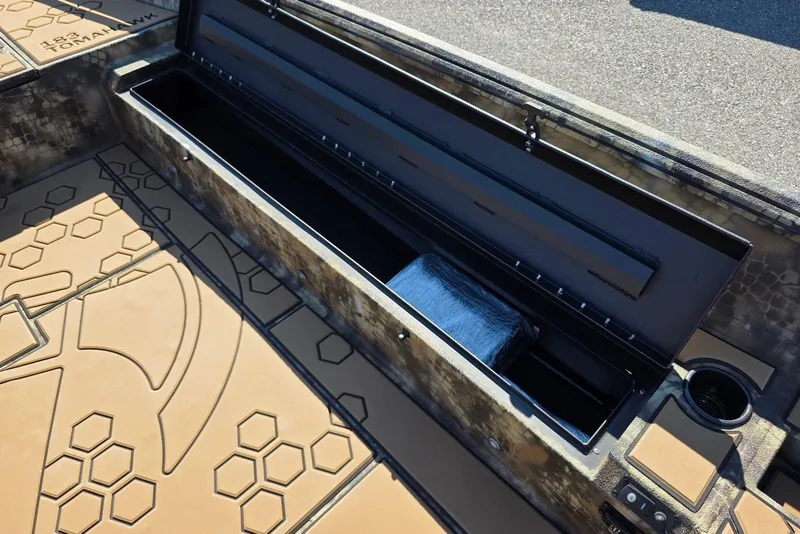 Slide: The Image of Open storage compartment in 2026 Excel 183 Tomahawk boat with hexagonal pattern flooring. - 14