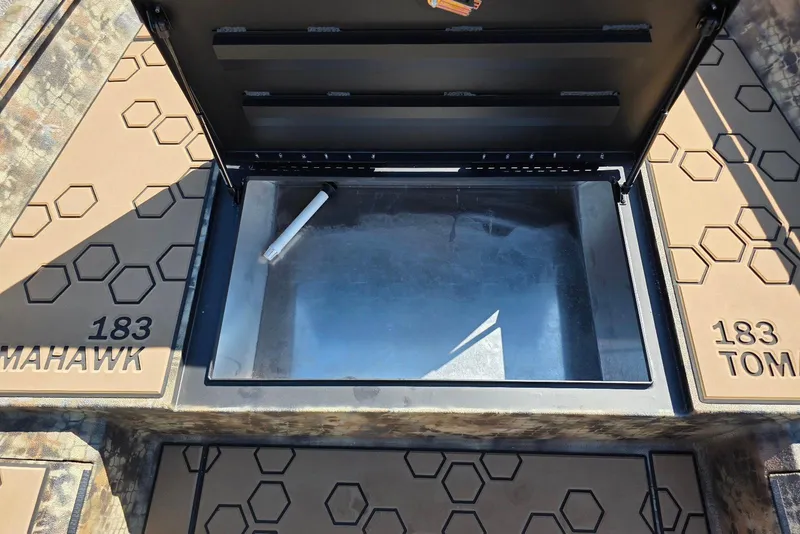 Slide: The Image of Open storage compartment in 2026 Excel 183 Tomahawk boat with hexagonal pattern design. - 18
